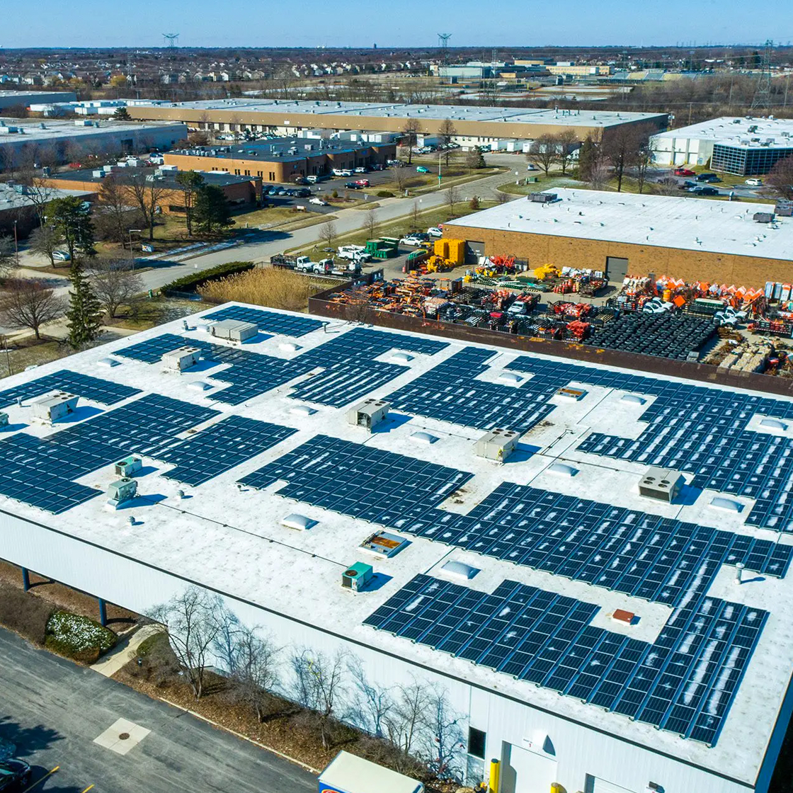 Aerial view of commercial solar installation on Illinois industrial building rooftop ComEd territory